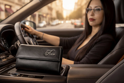 Aricio Mag Grande black leather wallet being held by a female model